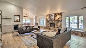 A spacious living room with a fireplace, a sofa, and a coffee table.
