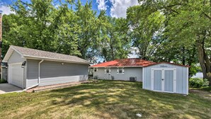 A residential property with a garage, a shed, and a house with a red roof. - Sunrise Bay w/ Lake Access: Families Welcome! (Isanti)
