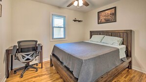A bedroom with a bed, a desk, a chair, a ceiling fan, a window, and a picture on the wall. - Sunrise Bay w/ Lake Access: Families Welcome! (Isanti)