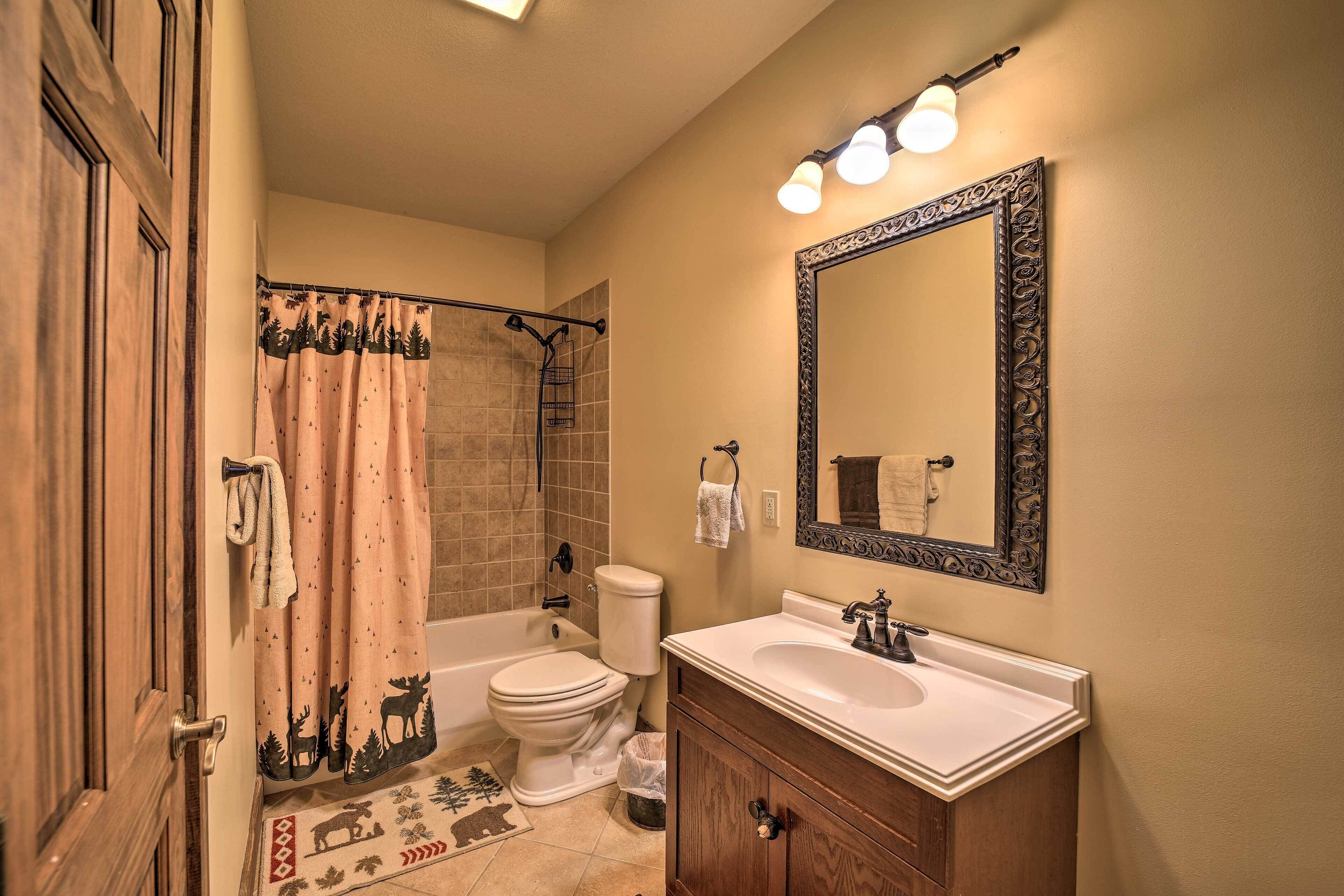 Une salle de bain avec une baignoire, des toilettes, un lavabo et un miroir.