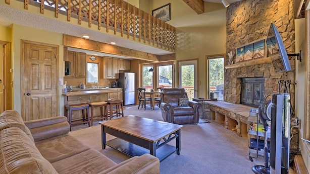 A spacious living area with a fireplace, a dining table, and a comfortable seating arrangement. - Townhome w/ Club Access on Shuttle Stop (Fraser)