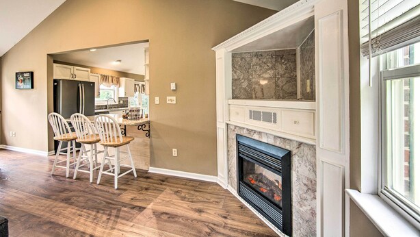 A dining area with wooden chairs and a kitchen in the background. - Family-friendly Coatesville House w/ Fire Pit (Coatesville)