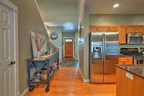 A modern kitchen with stainless steel appliances, wooden cabinets, and a central island. - 'bozeman Getaway' w/ Mountain Views, Near Downtown (Bozeman)