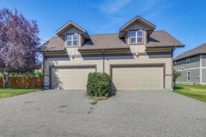 A two-story house with a garage, a small garden, and a wooden fence. - 'bozeman Getaway' w/ Mountain Views, Near Downtown (Bozeman)