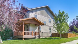 A two-story residential building with a covered porch and a fenced yard. - 'bozeman Getaway' w/ Mountain Views, Near Downtown (Bozeman)