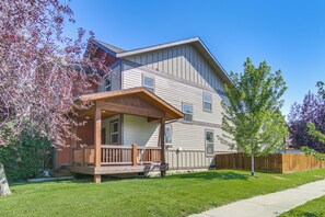 A two-story residential building with a covered porch and a fenced yard. - 'bozeman Getaway' w/ Mountain Views, Near Downtown (Bozeman)