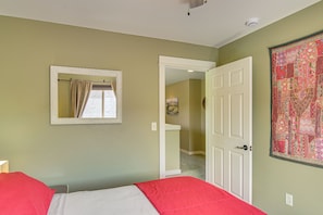 A bedroom with a bed, a door, a mirror, and a wall with a patterned tapestry. - 'bozeman Getaway' w/ Mountain Views, Near Downtown (Bozeman)