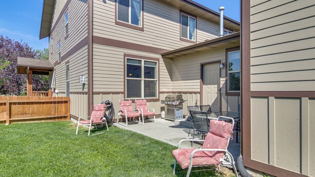 A two-story house with a patio area featuring outdoor furniture and a grill. - 'bozeman Getaway' w/ Mountain Views, Near Downtown (Bozeman)