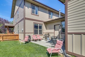 A two-story house with a patio area featuring outdoor furniture and a grill. - 'bozeman Getaway' w/ Mountain Views, Near Downtown (Bozeman)