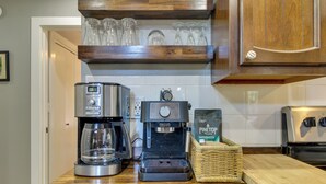 A kitchen with a coffee maker, a toaster, and a basket of coffee pods. - The Silly Goose A-frame Cabin in Pinetop-lakeside (Pinetop)