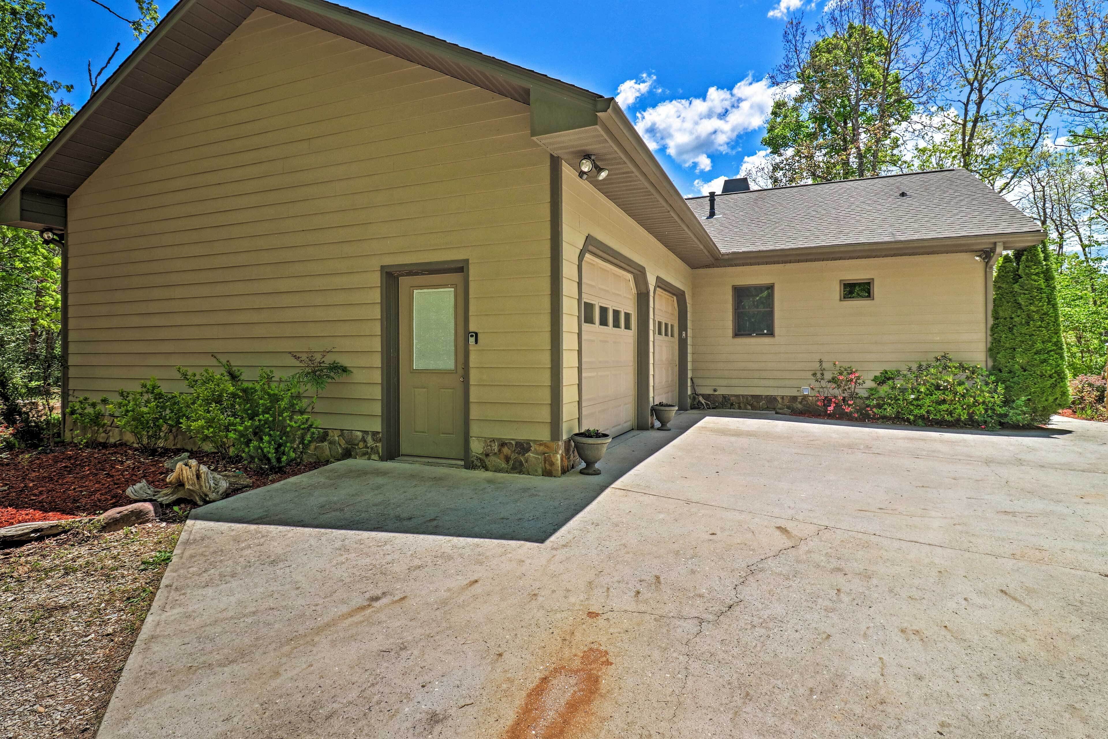 A two-story house with a garage, a front porch, and a driveway.