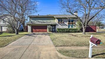 Stunning home with a charming front entrance, complete with a mailbox and beautifully manicured lawn.