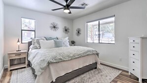 A bedroom with a bed, nightstand, dresser, ceiling fan, and decorative wall art. - ~ 8 Mi to State Park & Trails: Pine Mountain Home (Pine)
