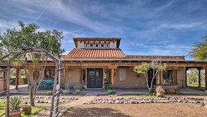 A traditional house with a tiled roof, a front porch, and a brick pathway leading to the entrance. - Pet-friendly Cave Creek Villa w/ Backyard Oasis! (Cave Creek)