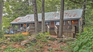 A rustic cabin with a metal roof, wooden deck, and a small porch area. - Waterfront Denmark Complex w/ Dock on 12 Acres! (Denmark)