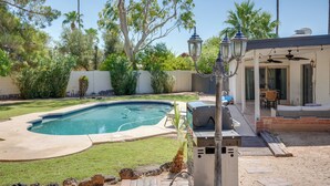 A backyard with a swimming pool, a barbecue grill, and a patio area with outdoor furniture. - Phoenix Home w/ Pool, Near Golf, Hiking & More! (Phoenix)