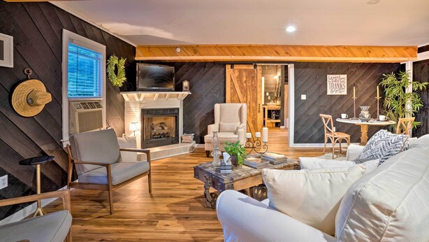 A cozy living room with a fireplace, comfortable seating, and a television. - Country-chic Waxhaw Studio w/ Pool Access! (Waxhaw)