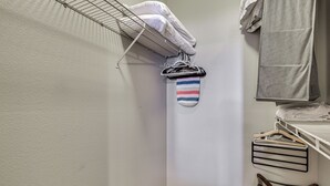 A laundry area with a drying rack, a hanging rack, and a shelf with folded clothes. - Close to Golfing & Shopping: Condo in Scottsdale! (Scottsdale)