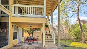 A two-story house with a covered patio, outdoor seating, and a staircase leading to the upper level. - Quiet Rental w/ Balcony: 14 Mi to Downtown Houston (Houston)