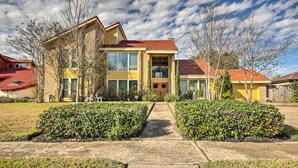 A two-story house with a red roof, large windows, and a front porch. - Quiet Rental w/ Balcony: 14 Mi to Downtown Houston (Houston)