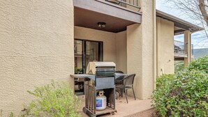 A barbecue grill with a propane tank outside a building. - Sedona Condo on Golf Course w/ Mountain Views! (Sedona)