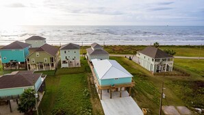 A coastal residential area with houses, a beach, and a view of the ocean. - Luxe Crystal Beach Retreat w/ Views! Walk to Shore (Port Bolivar)
