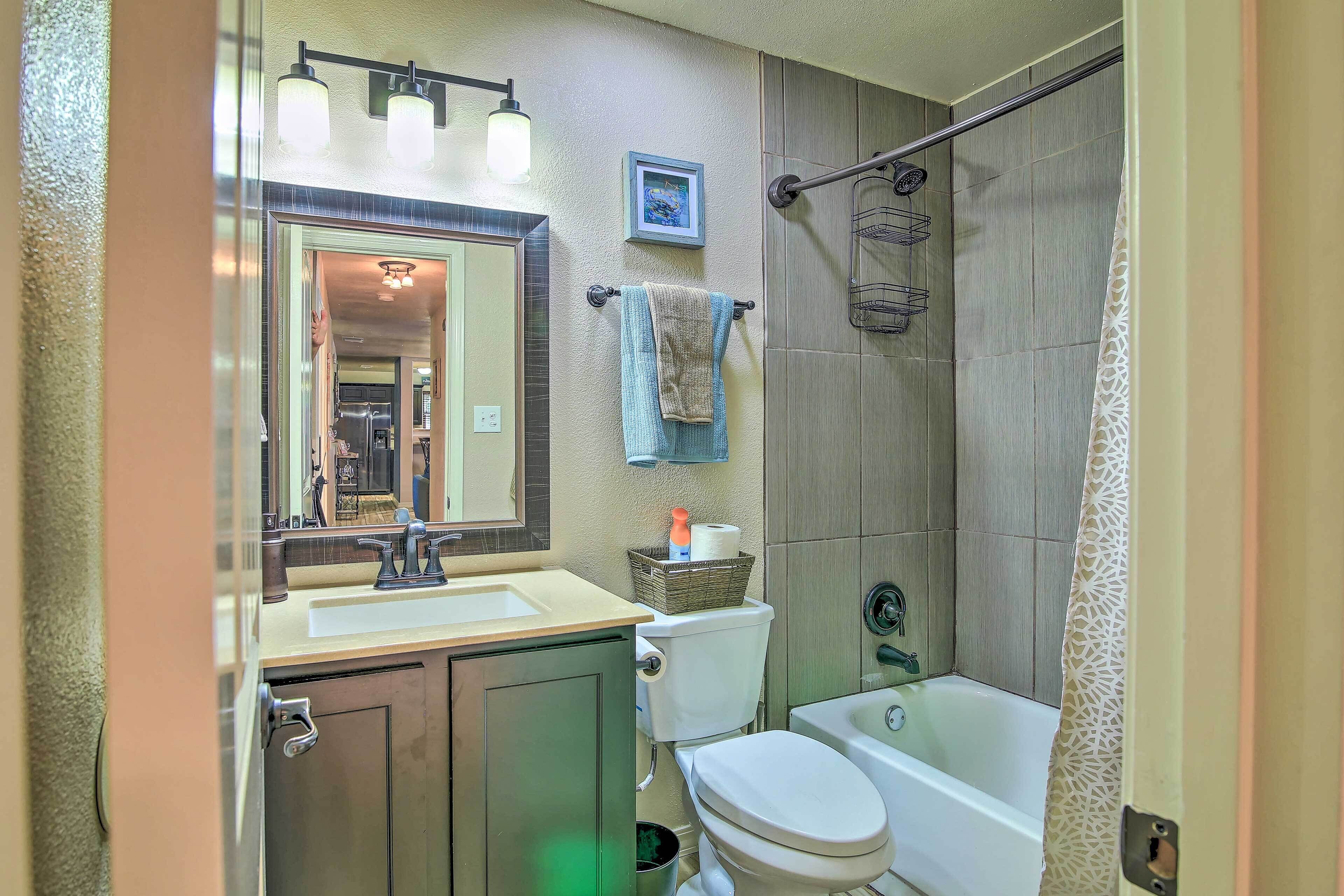 A bathroom with a toilet, sink, and bathtub.