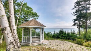 A gazebo with a tiled roof, surrounded by trees and a view of the water. - Enchanting Waterfront Sorrento Home w/ Deck! (Sorrento)