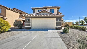 A residential building with a garage, a two-story structure, and a clear blue sky. - 'bella Casa' Coolidge Home w/ Pool & Hot Tub! (Coolidge)