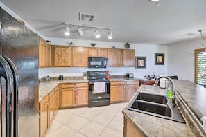 Enjoy cooking in this well-equipped kitchen with a central island, oven, and microwave.