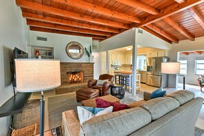 A spacious living room with a fireplace, leather furniture, and a high wooden ceiling. - Mid-century Modern Home 1 Mi to Nokomis Beach (Nokomis)