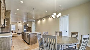 A spacious kitchen with a central island, wooden chairs around a round table, and recessed lighting. - Flagstaff Oasis w/ Hot Tub - 3 Mi to Downtown! (Flagstaff)