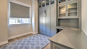 A kitchen with grey cabinets, a stainless steel countertop, and a patterned rug. - Flagstaff Oasis w/ Hot Tub - 3 Mi to Downtown! (Flagstaff)