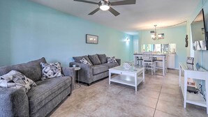 A living room with a grey sofa, a white coffee table, and a ceiling fan. - Sweet Snowbird Escape ~ 2 Mi to St Pete Beach (St. Petersburg)