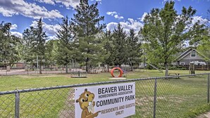 A fenced community park with playground equipment and a sign indicating it is for residents and guests only. - Tonto Nat'l Forest Riverside Cabin! (Payson)