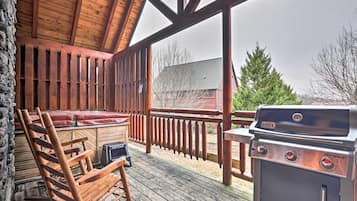 Enjoy al fresco dining on this outdoor deck with a grill and comfortable seating.