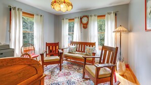 A cozy room with a wooden bench, chairs, a desk, and a lamp. - Upper Valley Retreat on 15 Acres Near Dartmouth (Meriden)