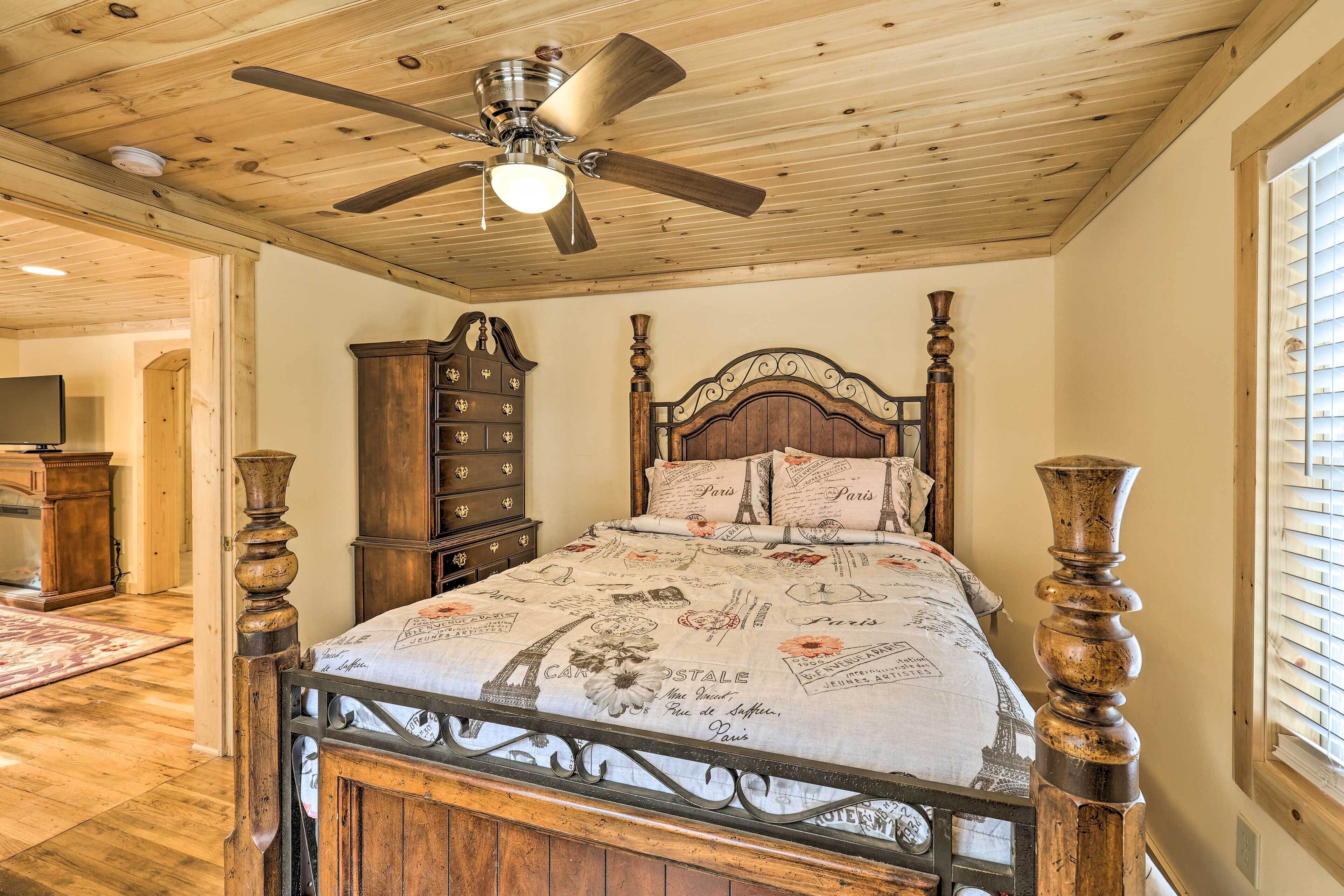 Ein Schlafzimmer mit Holzboden, einem Bett mit dekorativer Kopfstütze, einem Schminktisch und einem großen Spiegel.