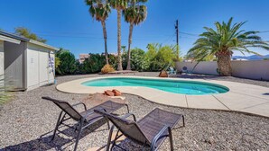 A backyard with a swimming pool, palm trees, and outdoor furniture. - Lake Havasu Getaway w/ Pool, Hot Tub & Game Room (Lake Havasu City)