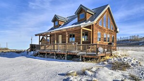 A wooden cabin with a porch, large windows, and a sloped roof. - 'off The Beaten Path' Cabin w/ Mtn Views & Hot Tub (Red Lodge)