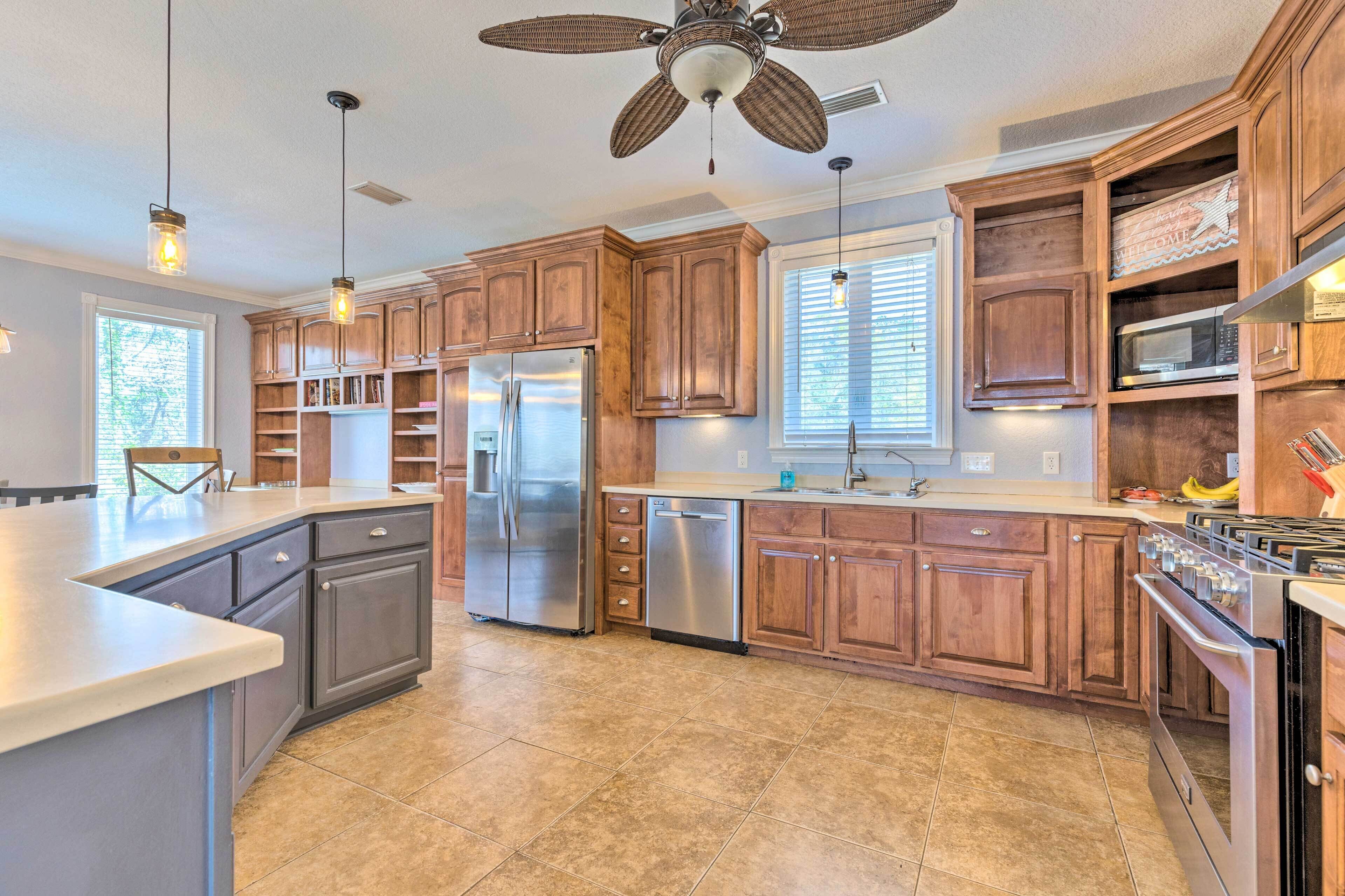 A spacious kitchen with wooden cabinets, stainless steel appliances, and a large island.