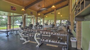 A gym with various exercise equipment, benches, and dumbbells. - Waterfront Lake Travis Home w/ Pool Access! (Leander)