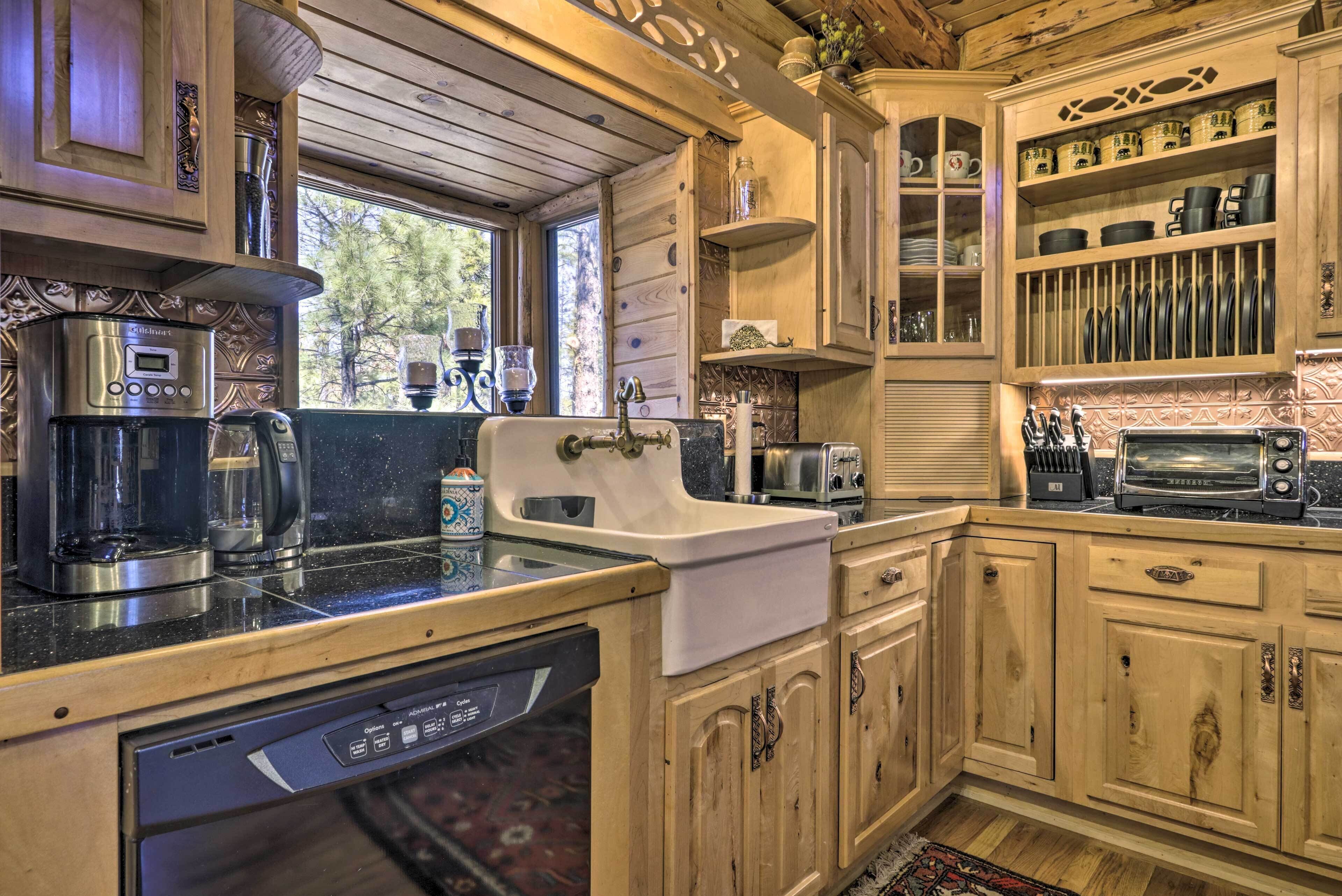 A wooden cabin-style kitchen with a coffee maker, toaster, and dishwasher.