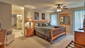 A bedroom with a wooden bed, bedside lamps, a ceiling fan, and a large mirror. - Golf, Hike & Suntan: Mesa Family Home w/ Yard (Mesa)