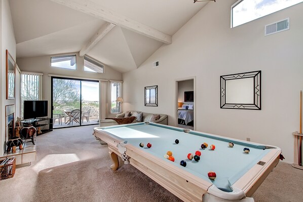 A spacious room with a pool table, a television, and a cozy seating area with a view of the outdoors. - Borrego Springs Hideaway: Pool Table, Mtn Views! (Borrego Springs)