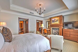 A hotel room with a large bed, a television, a fireplace, and a desk. - Luxe Montage Deer Valley Retreat: Ski-in/ski-out! (Park City)