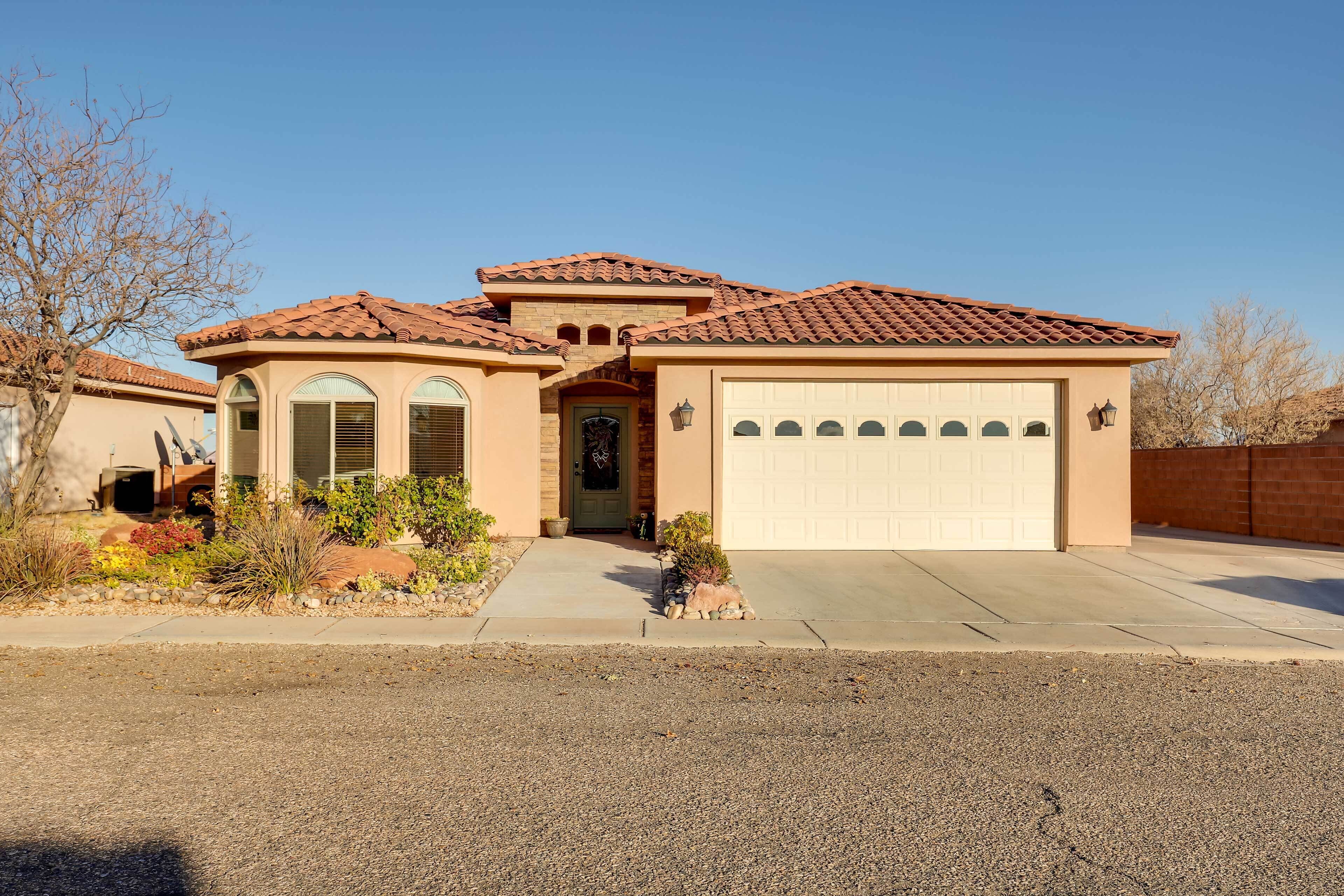 A single-story house with a garage, a front entrance, and a small porch area.