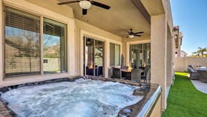 A hot tub with a patio area, including outdoor furniture and a ceiling fan. - Group Fun in Glendale! Getaway w/ Private Pool (Glendale)