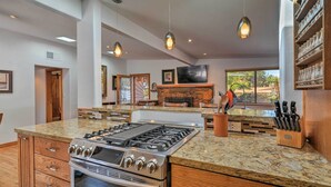 A modern kitchen with a large island, built-in oven, and gas stove. - Patio & Views: Peaceful Sedona Getaway! (Sedona)