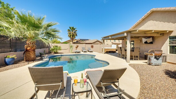 A backyard with a swimming pool, lounge chairs, and a barbecue area. - Backyard Oasis: Updated San Tan Valley Escape (San Tan Valley)